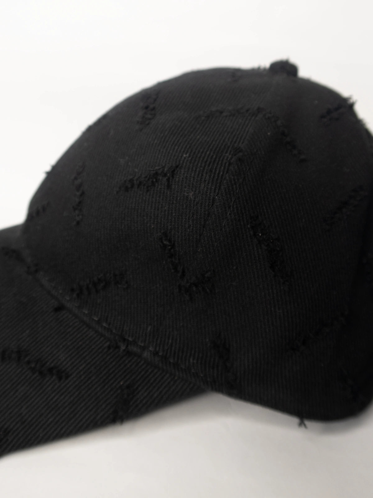 Black distressed baseball cap on a white background