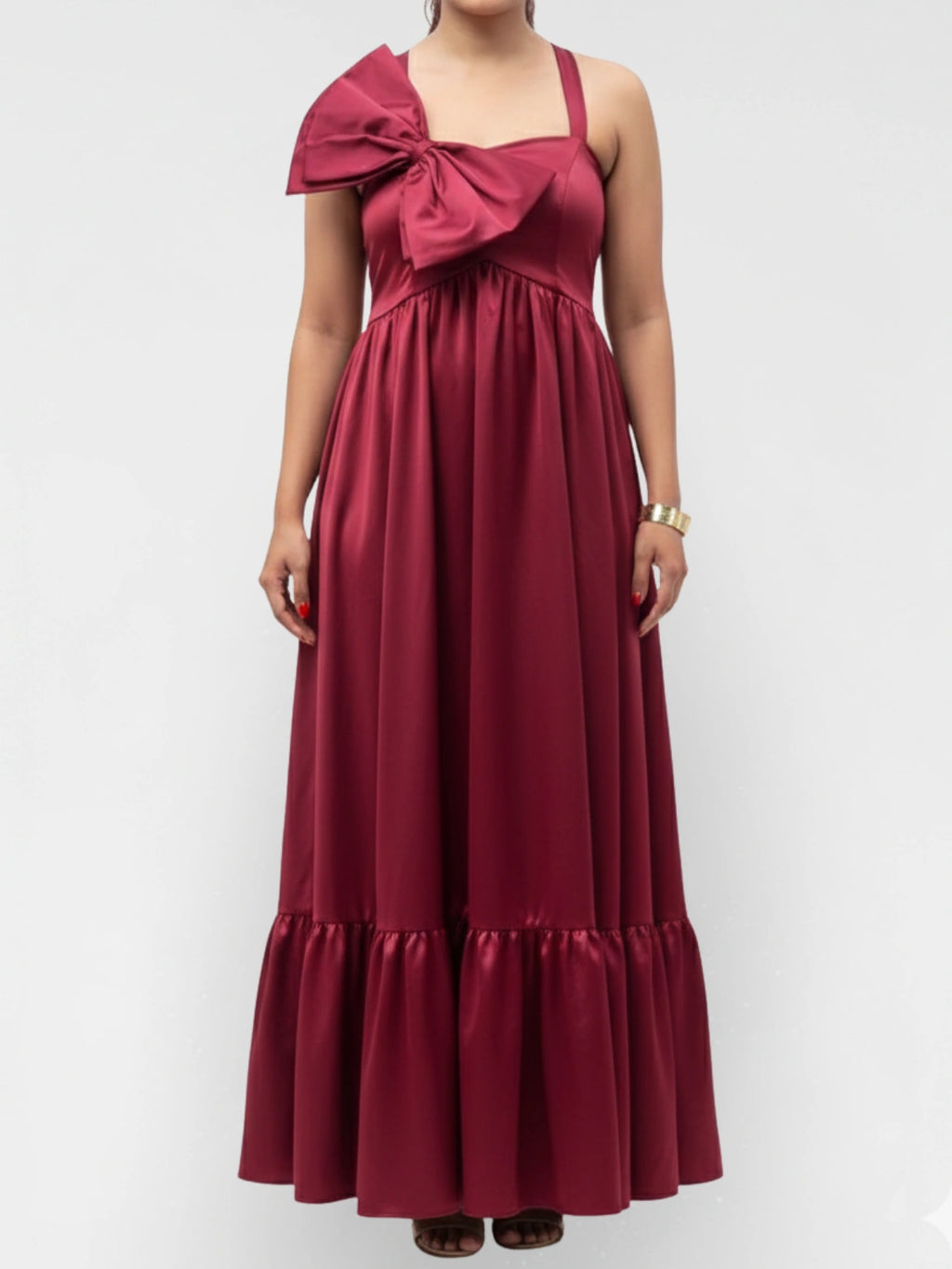 Red evening gown with a large bow detail on a white background