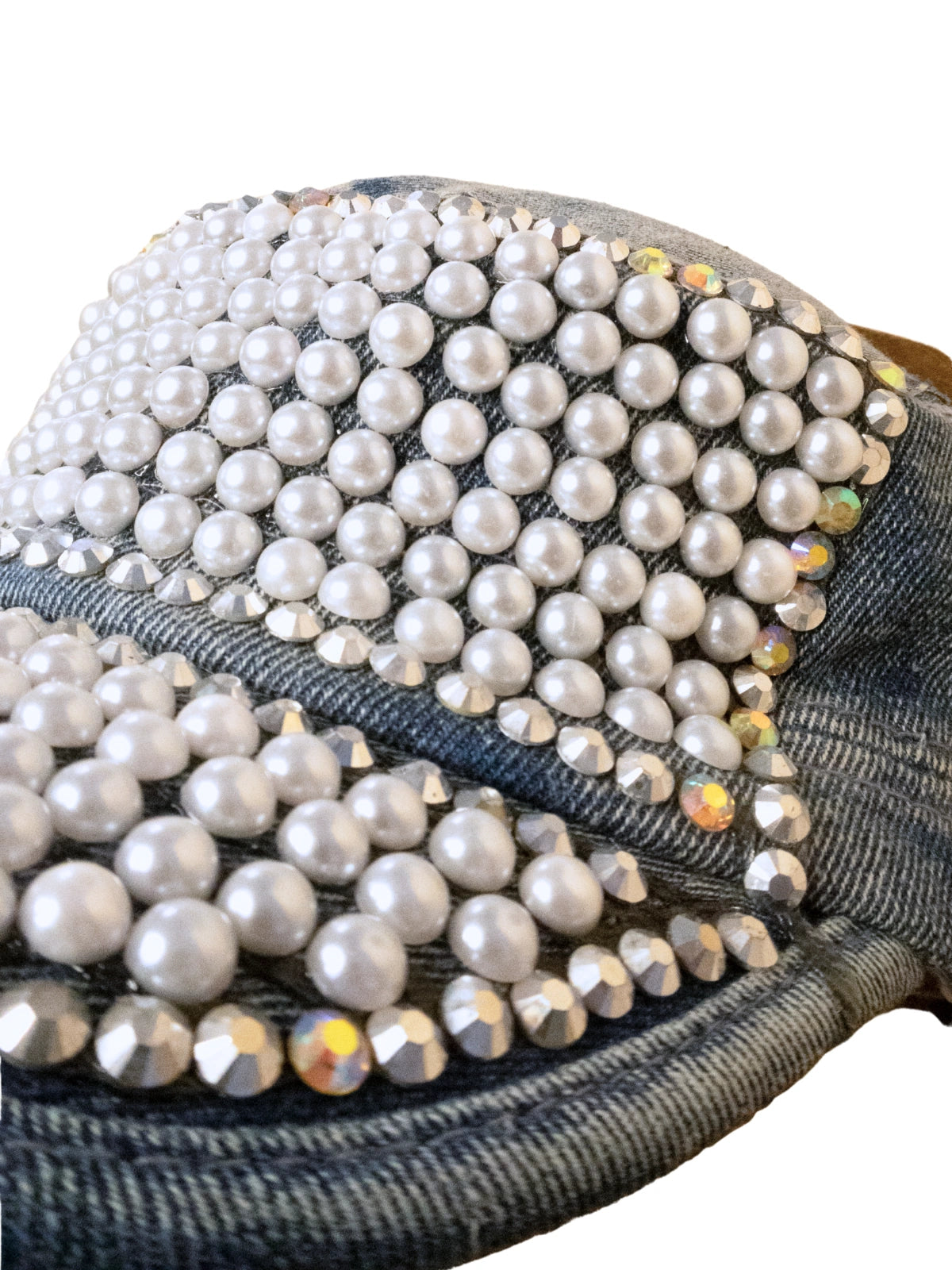 Black cap with pearls and rhinestones on a white background