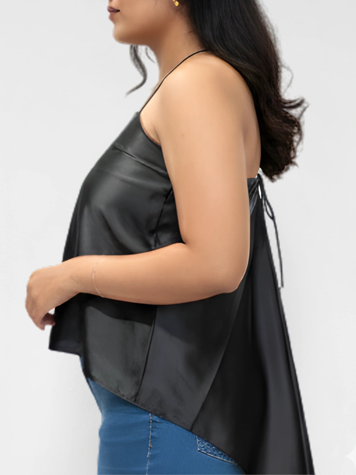Woman wearing a black sleeveless top with a white background