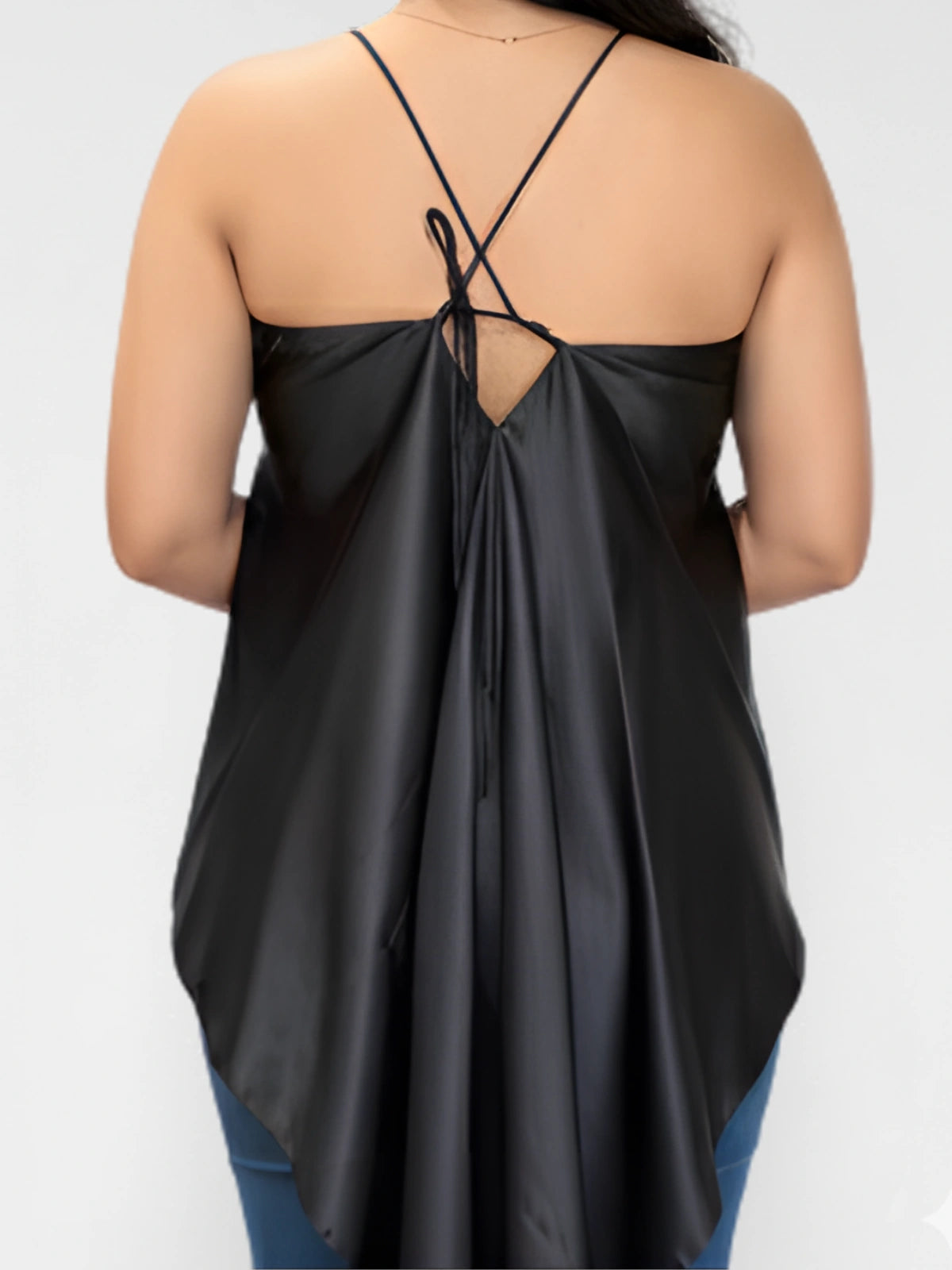 Black sleeveless top with open back worn by a person on a white background