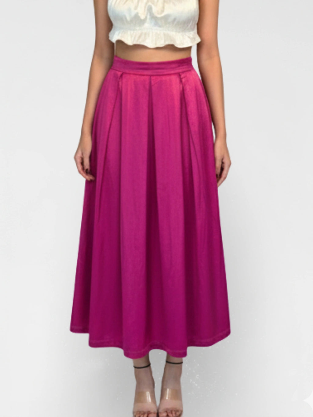 Person wearing a bright pink skirt on a white background