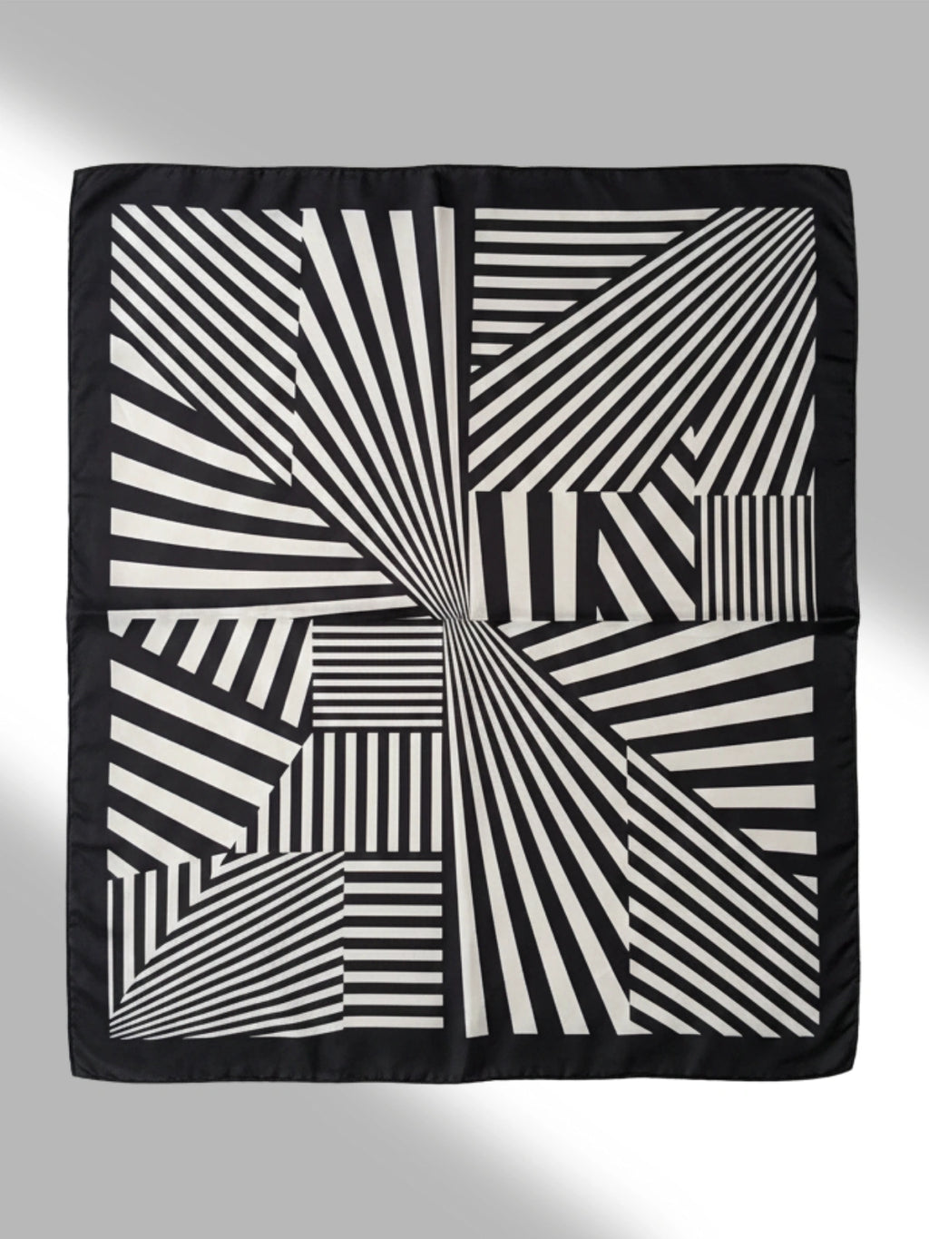 Black and white geometric patterned fabric on a gray background
