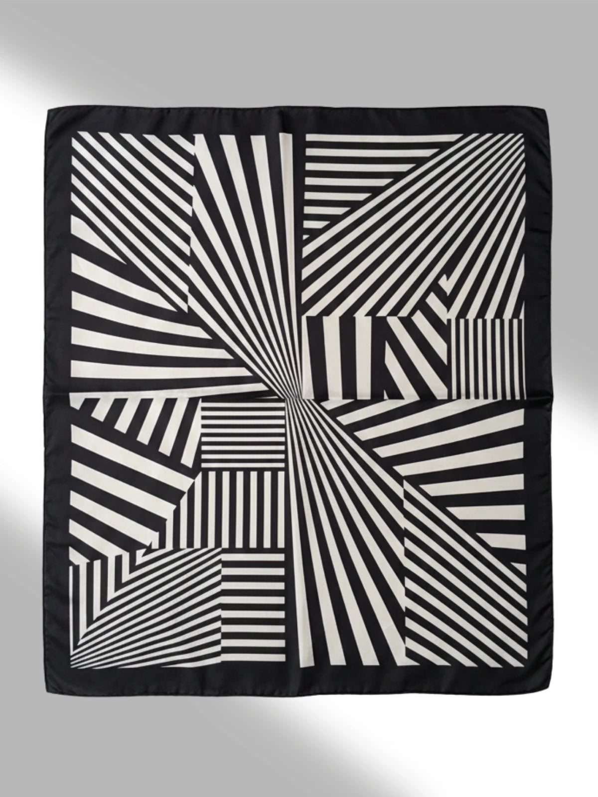 Black and white geometric patterned fabric on a gray background