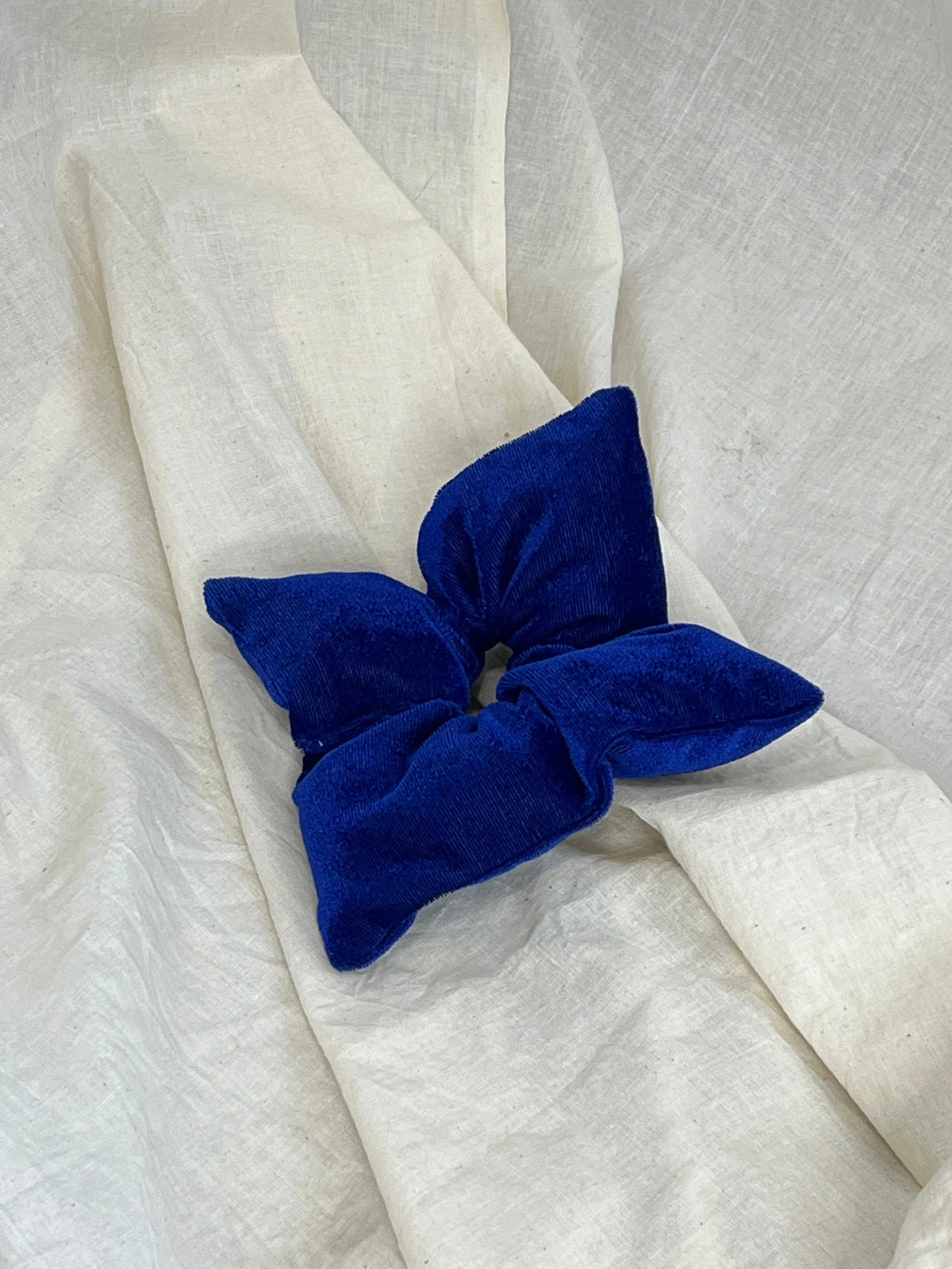 Blue bow on a white fabric background
