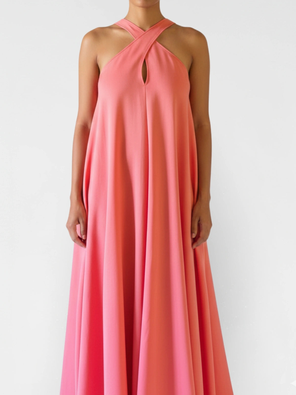 Coral pink halter neck dress on a white background